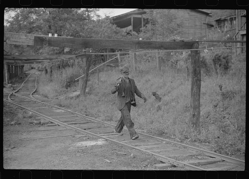 Coal miner returning from work with pick over shoulder. The "Patch," Chaplin, West Virginia