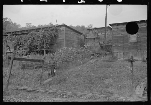 Untitled photo, possibly related to: Coal miners switching motor. Note live wires. The "Patch," Chaplin, West Virginia