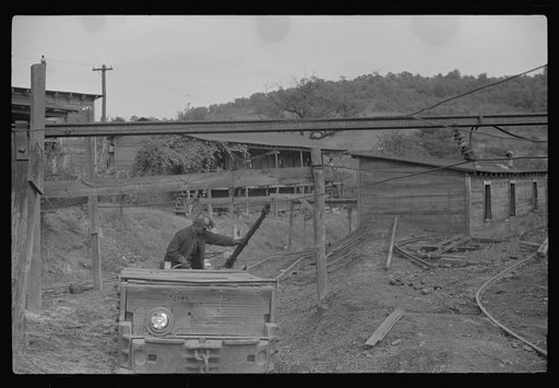 Untitled photo, possibly related to: Coal miners switching motor. Note live wires. The "Patch," Chaplin, West Virginia