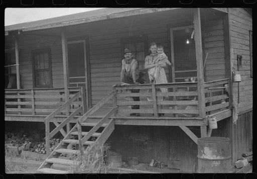 Coal miner, his wife and baby living in one of shanties seen in nos. 30144-M2 and 30151-M1. Scotts Run, West Virginia