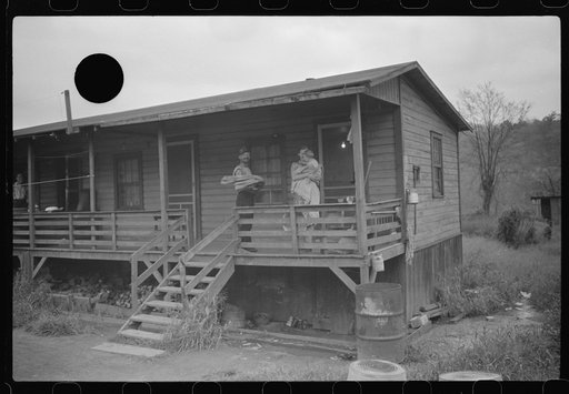 Untitled photo, possibly related to: Coal miner, his wife and baby living in one of shanties seen in nos. 30144-M2 and 30151-M1. Scotts Run, West Virginia