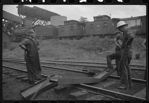 Untitled photo, possibly related to: Workman cutting a steel beam with an acetylane torch near mine tipple and engine house. Scotts Run, West Virginia