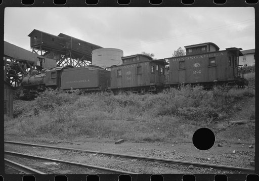 Untitled photo, possibly related to: Workman cutting a steel beam with an acetylane torch near mine tipple and engine house. Scotts Run, West Virginia