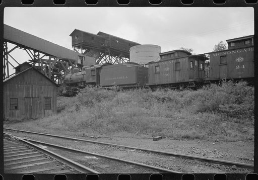 Untitled photo, possibly related to: Workman cutting a steel beam with an acetylane torch near mine tipple and engine house. Scotts Run, West Virginia