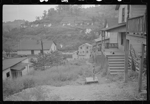 Untitled photo, possibly related to: Coal miner's wife getting water from pump, company houses, Pursglove, Scotts Run, West Virginia