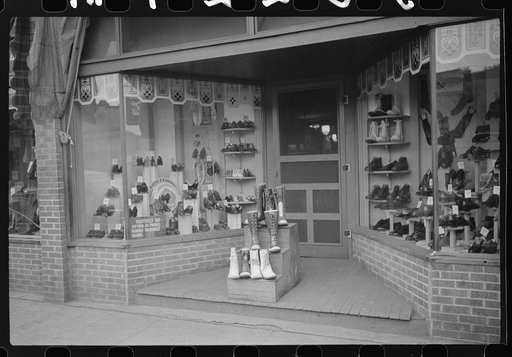 Shoe store with miners safety boots on display in foreground, Scotts Run, West Virginia