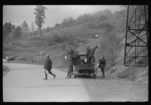 Coal miners coming to work in friend's truck; pay him for their rides. Maidsville, West Virginia