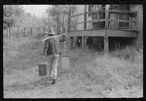 Mexican miner carrying water the way he learned as a boy, from about two miles downhill. Bertha Hill, West Virginia