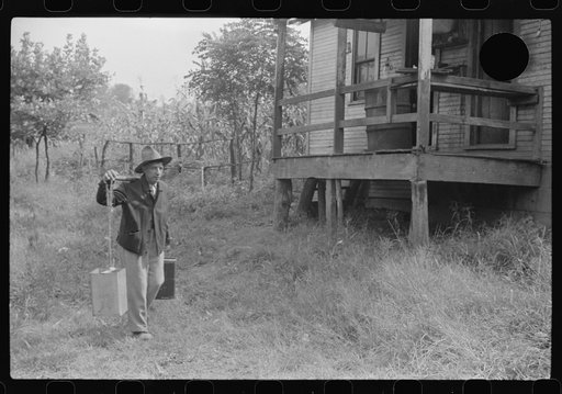 Untitled photo, possibly related to: Mexican miner carrying water the way he learned as a boy, from about two miles downhill. Bertha Hill, West Virginia