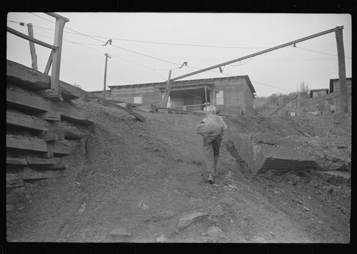 Untitled photo, possibly related to: Coal miner's son carrying home bag of coal swiped from cars. The "Patch," Chaplin, West Virginia