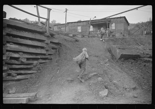 Coal miner's son carrying home bag of coal swiped from cars. The "Patch," Chaplin, West Virginia