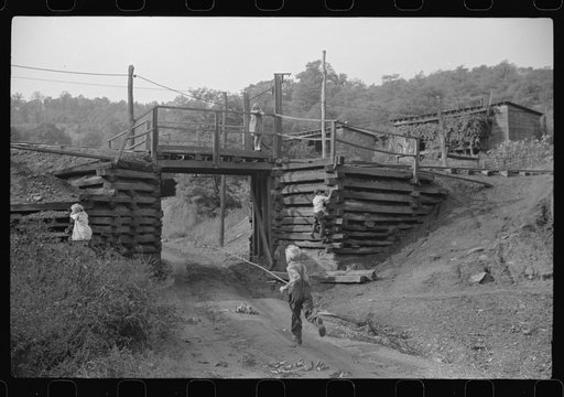 Coal miner's children playing around tracks. Note live wires. Chaplin, West Virginia