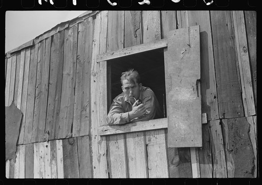 Untitled photo, possibly related to: Coal miner looks out of window in his home, Bertha Hill, Scotts Run, West Virginia