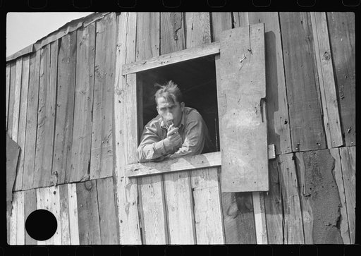 Untitled photo, possibly related to: Coal miner looks out of window in his home, Bertha Hill, Scotts Run, West Virginia