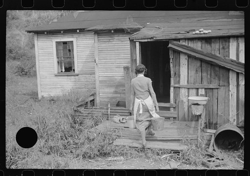 Untitled photo, possibly related to: Coal miner's wife carrying water from up the hill, Bertha Hill, West Virginia
