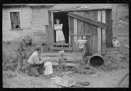 Coal miner and some of his family in back of their home. Bertha Hill, West Virginia