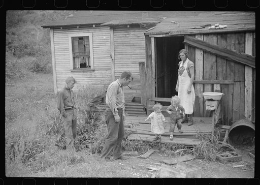 Untitled photo, possibly related to: Coal miner and some of his family in back of their home. Bertha Hill, West Virginia