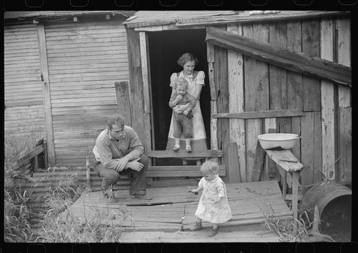 Untitled photo, possibly related to: Coal miner and some of his family in back of their home. Bertha Hill, West Virginia