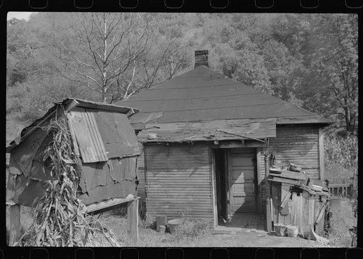 Rear of coal miner's home and homemade corn crib at left. There's not any water or electricity. Bertha Hill, West Virginia