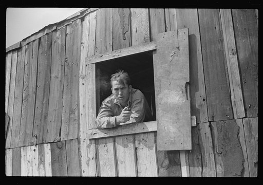 Coal miner looks out of window in his home, Bertha Hill, Scotts Run, West Virginia