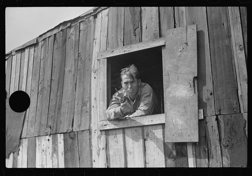 Untitled photo, possibly related to: Coal miner looks out of window in his home, Bertha Hill, Scotts Run, West Virginia