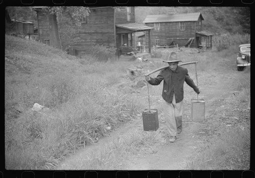 Mexican miner carrying water up the hill to his home, about two miles. Bertha Hill, West Virginia