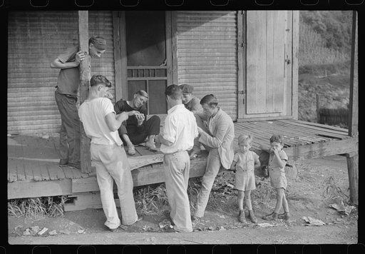 Coal miners card gambling Saturday afternoon on porch of company store, Chaplin, West Virginia