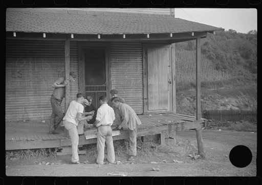 Untitled photo, possibly related to: Coal miners card gambling Saturday afternoon on porch of company store, Chaplin, West Virginia