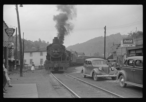 Train pulling coal through center of town morning and evening, Osage, West Virginia