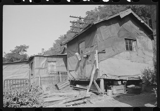Shacks inhabited by Negroes along river on highway between Charleston and Gauley Bridge, West Virginia