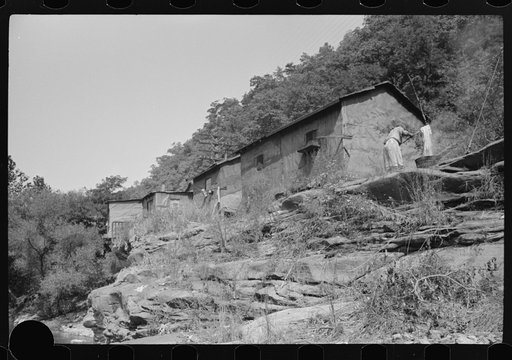 Untitled photo, possibly related to: Shacks inhabited by Negroes along river on highway between Charleston and Gauley Bridge, West Virginia