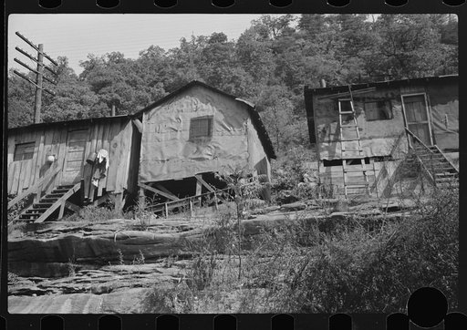 Untitled photo, possibly related to: Shacks inhabited by Negroes along river on highway between Charleston and Gauley Bridge, West Virginia