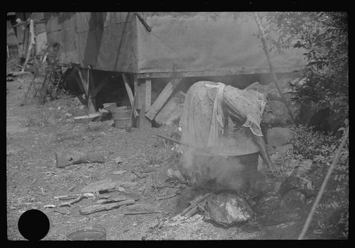 Untitled photo, possibly related to: Negro woman washing clothes outside of shacks along the river, on the highway between Charleston and Gauley Bridge, West Virginia