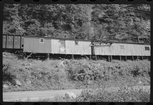 Untitled photo, possibly related to: Old boxcars often converted into homes along highway between Charleston and Gauley Bridge, West Virginia