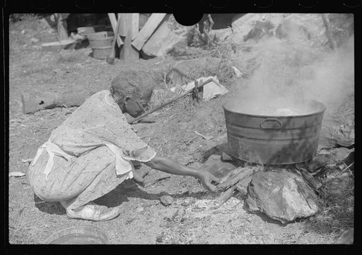 Untitled photo, possibly related to: Negro woman washing clothes outside of shacks along the river, on highway between Charleston and Gauley Bridge, West Virginia