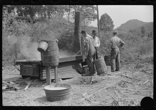 Untitled photo, possibly related to: Boiling juice of sugarcane into sorghum molasses. Racine, West Virginia