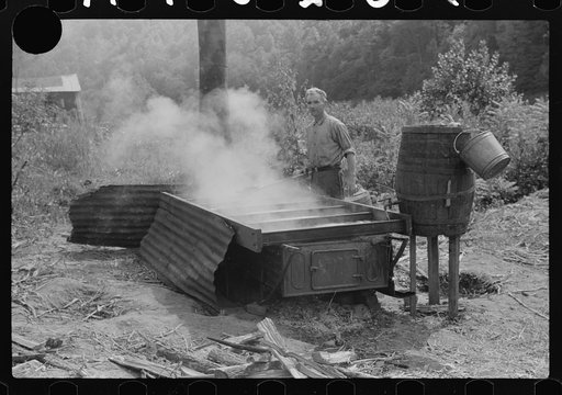 Untitled photo, possibly related to: Racine, West Virginia. Making molasses is hot work