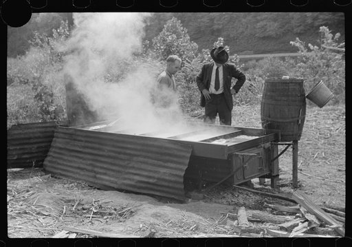 Untitled photo, possibly related to: Racine, West Virginia. Making molasses is hot work