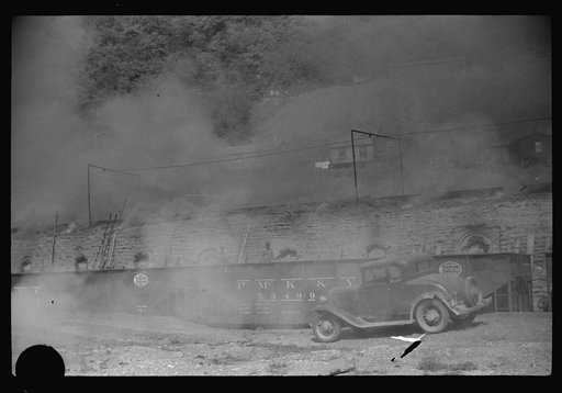 Untitled photo, possibly related to: Coke ovens and burning slag heaps make heavy impenetrable smoke over whole town, day and night. Longacre, West Virginia