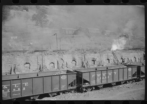 Untitled photo, possibly related to: Coke ovens make heavy impenetrable smoke over whole town. Workers' homes in background. Longacre, West Virginia