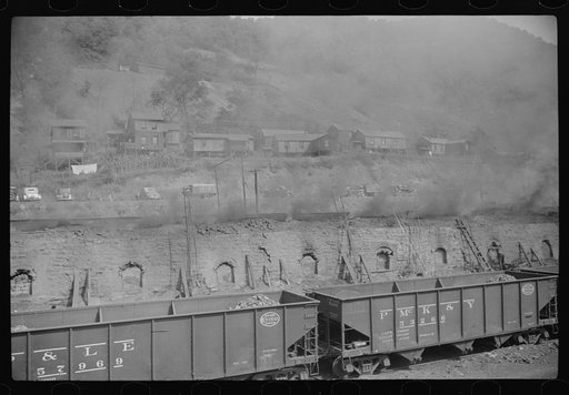 Coke ovens make heavy impenetrable smoke over whole town. Workers' homes in background. Longacre, West Virginia