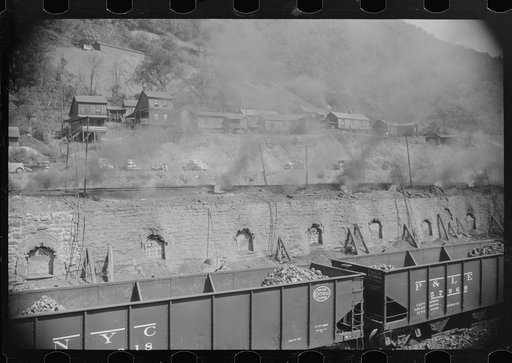Untitled photo, possibly related to: Coke ovens make heavy impenetrable smoke over whole town. Workers' homes in background. Longacre, West Virginia