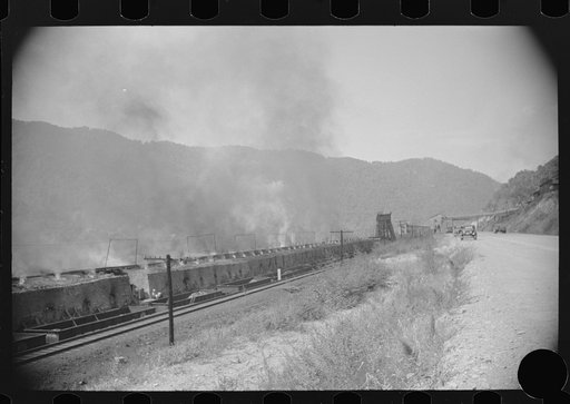 Untitled photo, possibly related to: Coke ovens and burning slag heaps make heavy impenetrable smoke over whole town, day and night. Longacre, West Virginia