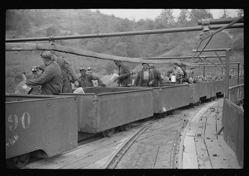 Untitled photo, possibly related to: The "trip" coming out of the mines at the end of the day shift. This mine has many safety regulations. The men cannot leave their car until the one in front has been emptied. Maidsville, West Virginia