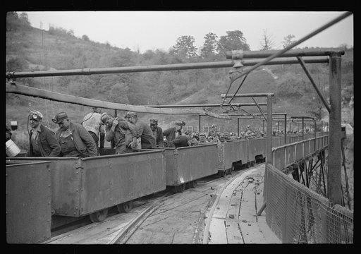 The "trip" coming out of the mines at the end of the day shift. This mine has many safety regulations. The men cannot leave their car until the one in front has been emptied. Maidsville, West Virginia