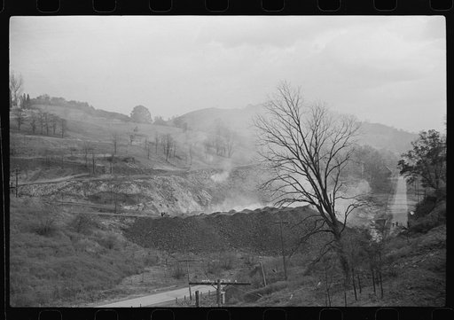 General view from top of coal mine tressle, showing burning slag heaps and holes of slate, Maidsville, West Virginia