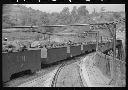 The "trip" coming out of the mines at the end of the day shift. Maidsville, West Virginia. This mine had many safety regulations. The men must be seated until motor is stopped and then the cars emptied, one by one