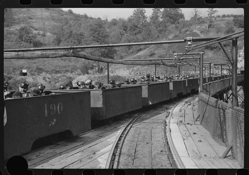 Untitled photo, possibly related to: The "trip" coming out of the mines at the end of the day shift. Maidsville, West Virginia. This mine had many safety regulations. The men must be seated until motor is stopped and then the cars emptied, one by one