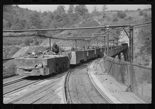 The "trip" coming out of the mines at the end of the day shift. Maidsville, West Virginia. This mine had many safety regulations. The men must be seated until motor is stopped and then the cars emptied, one by one