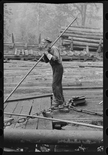 Men spiking logs to go to ramp into sawmill. It was working only halftime and was even slower in winter. "It's kinder hard them times. Concrete and steel's taking the place of lumber nowadays. Erwin, West Virginia